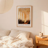 a bedroom setting with a framed poster of a church scene hanging on the wall above a bed with striped bedding.