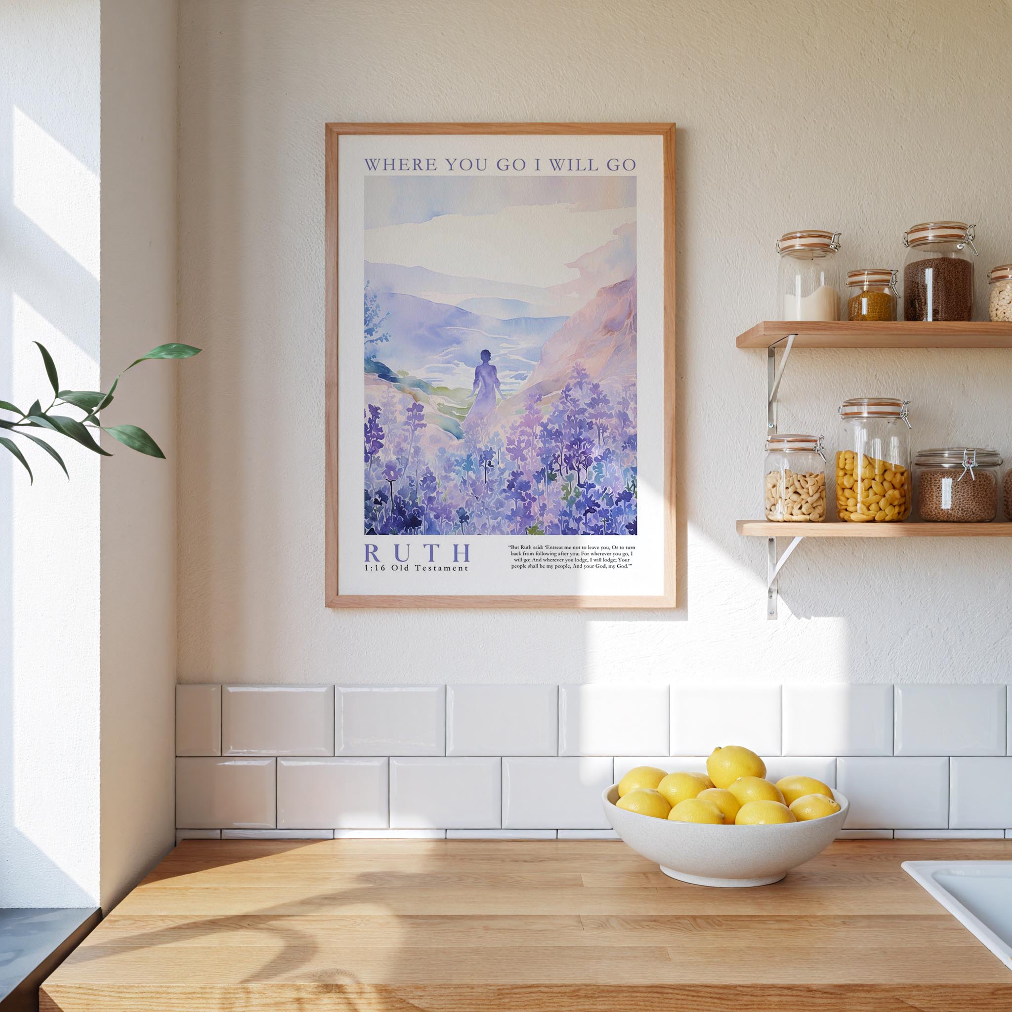 a kitchen counter with a bowl of lemons, a framed poster of a mountain landscape, and a shelf with jars and other kitchen items.