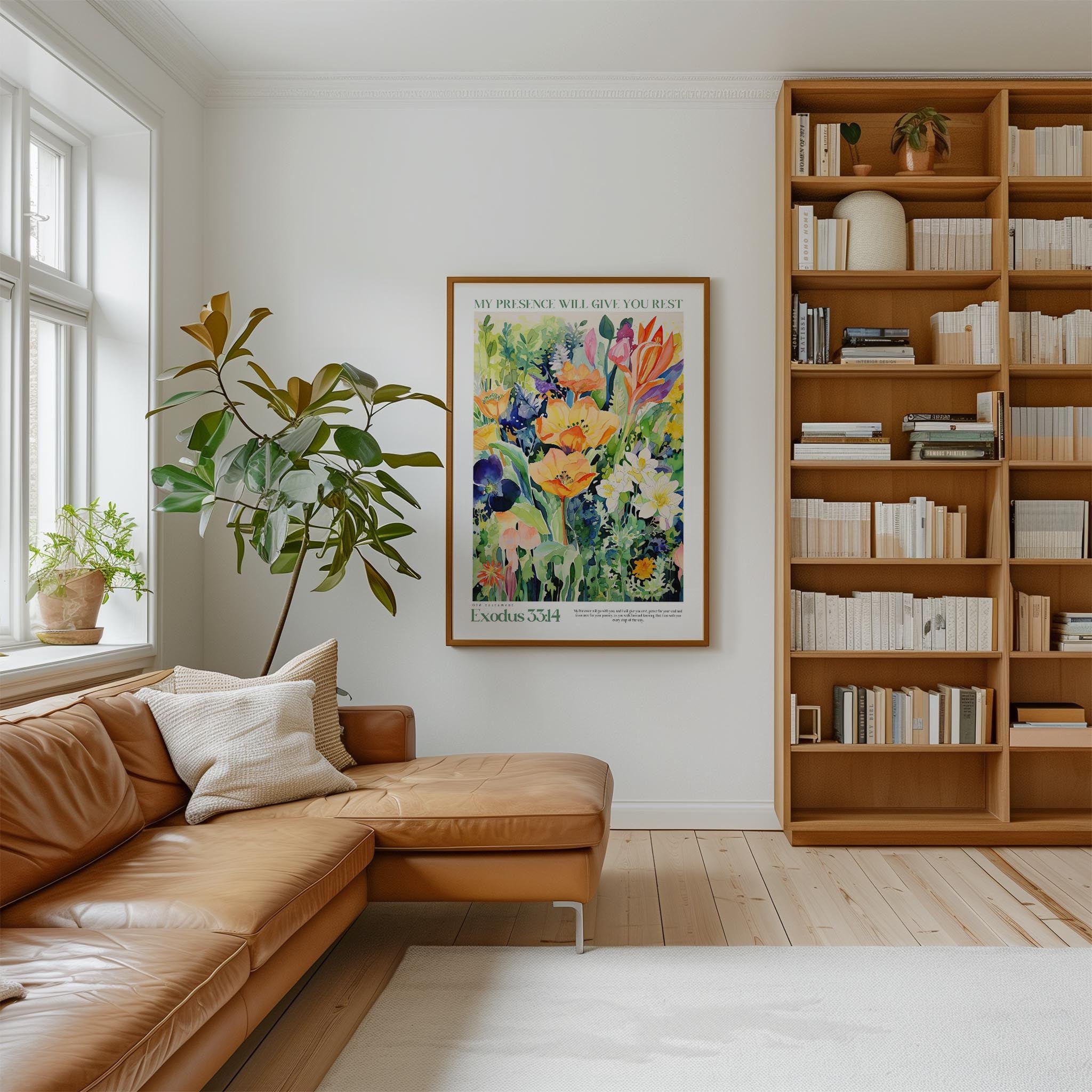a cozy living room with a large bookshelf filled with books, a comfortable leather couch, and a large framed poster of a colorful floral painting hanging on the wall.