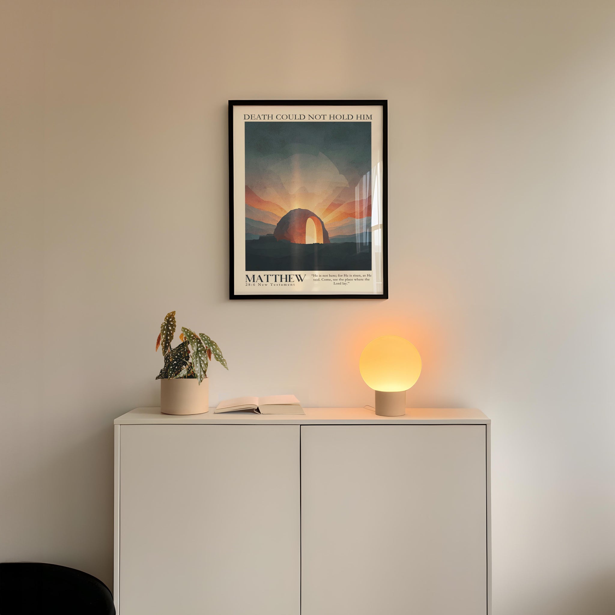a minimalist interior design with a white cabinet, a potted plant, and a framed poster on the wall.