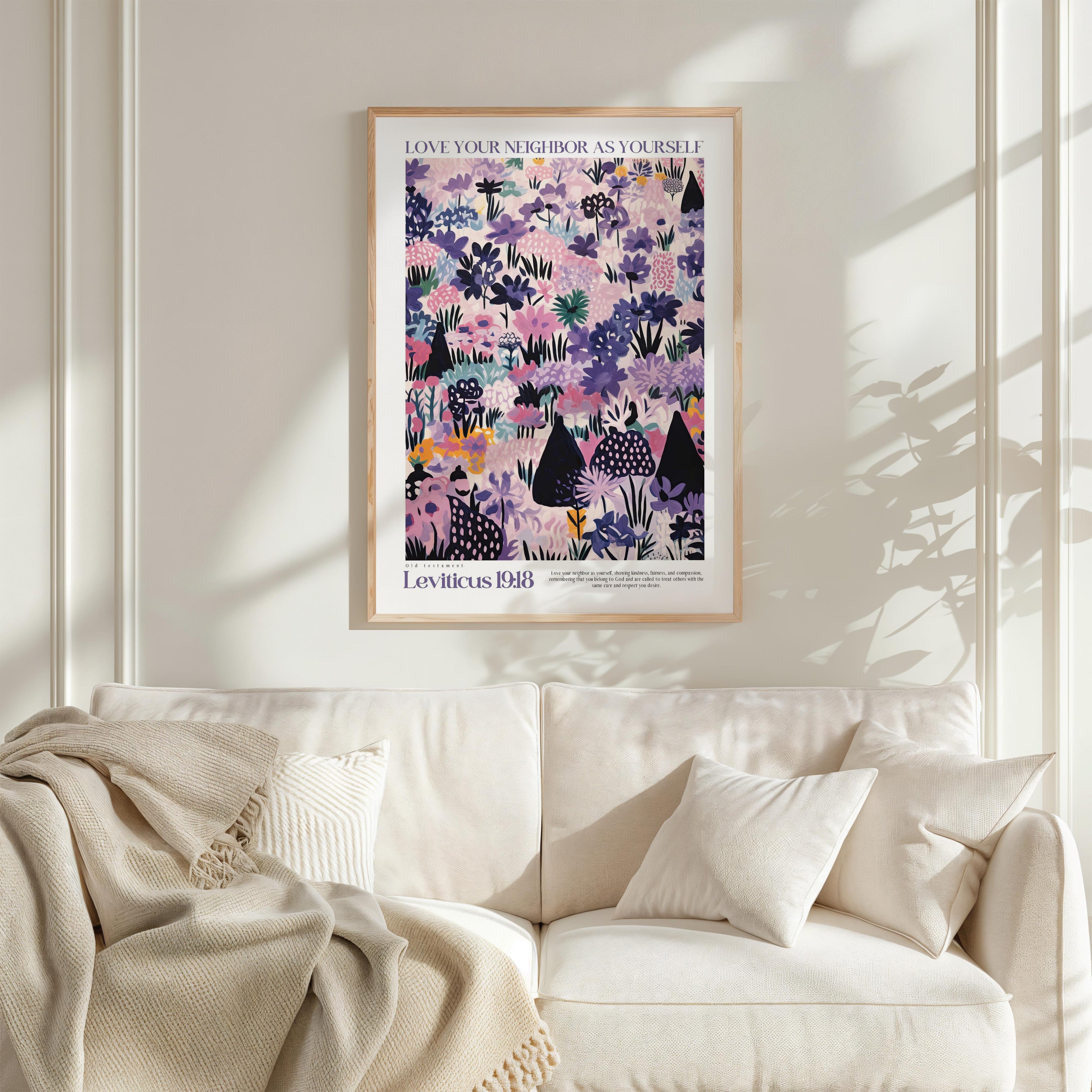 a framed poster of a colorful floral pattern hanging on a wall above a white couch with pillows.