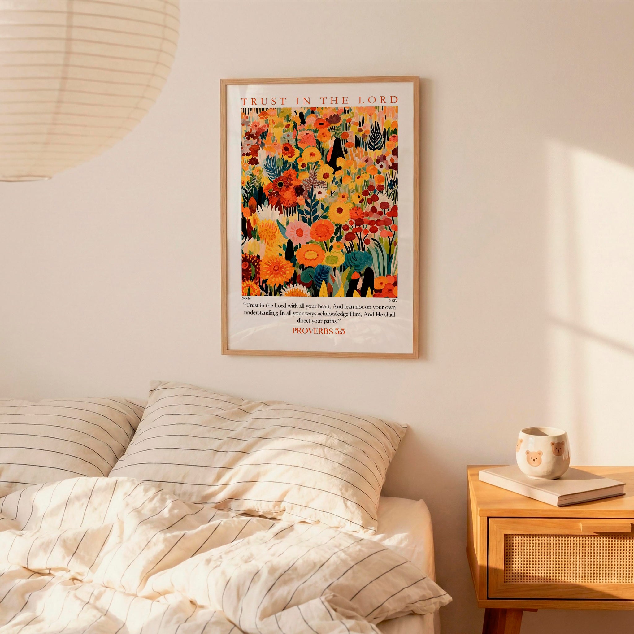 a bedroom scene with a bed, a nightstand, and a poster of a colorful floral design hanging on the wall above the bed.