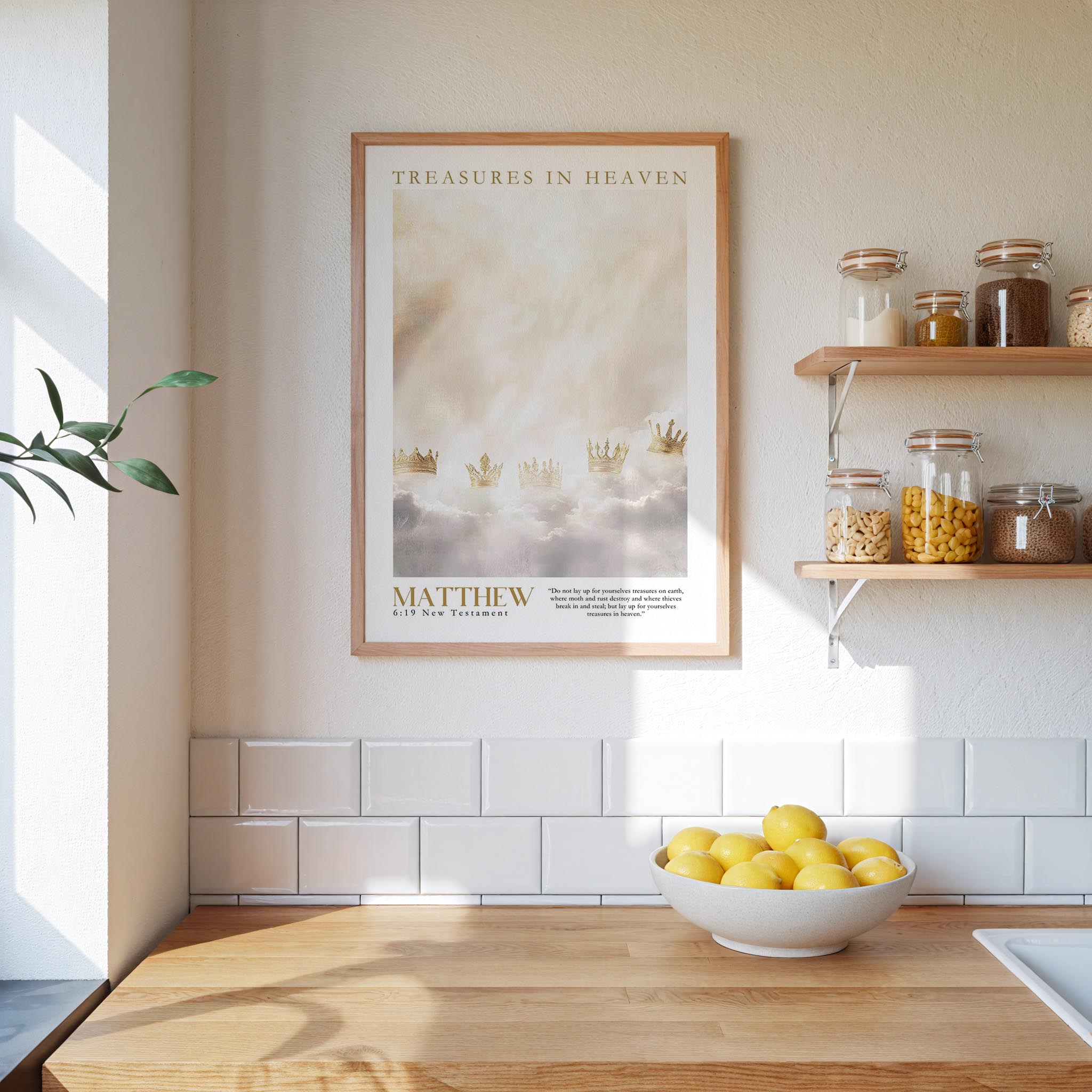 A framed poster of a cloudy sky with crowns hangs on a white wall above a wooden countertop with a bowl of lemons.