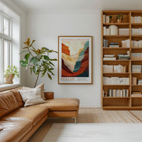 a cozy living room with a large bookshelf filled with books, a comfortable leather couch, and a large abstract painting hanging on the wall.