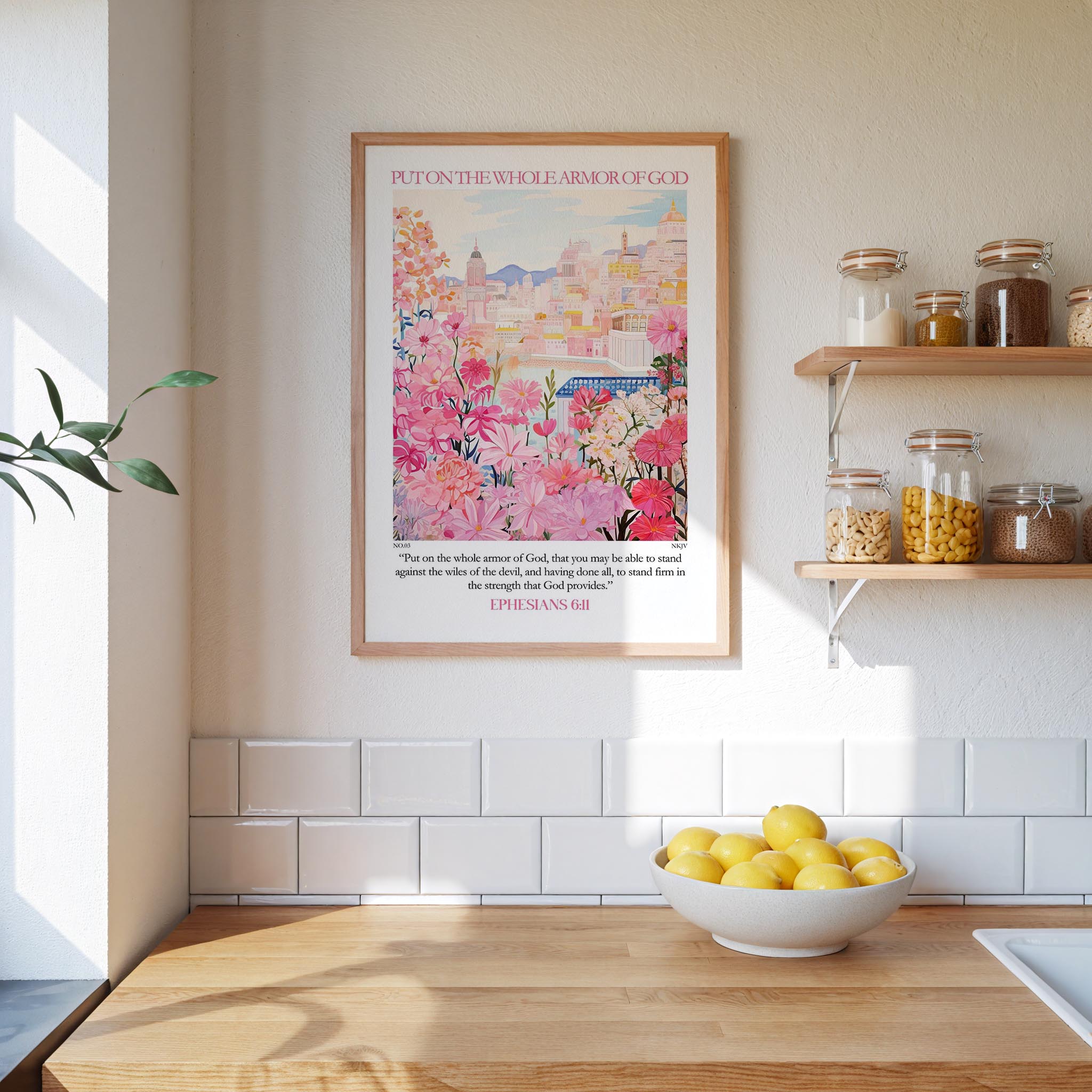 A framed poster of a cityscape with pink flowers hangs on a wall above a wooden countertop with a bowl of lemons.
