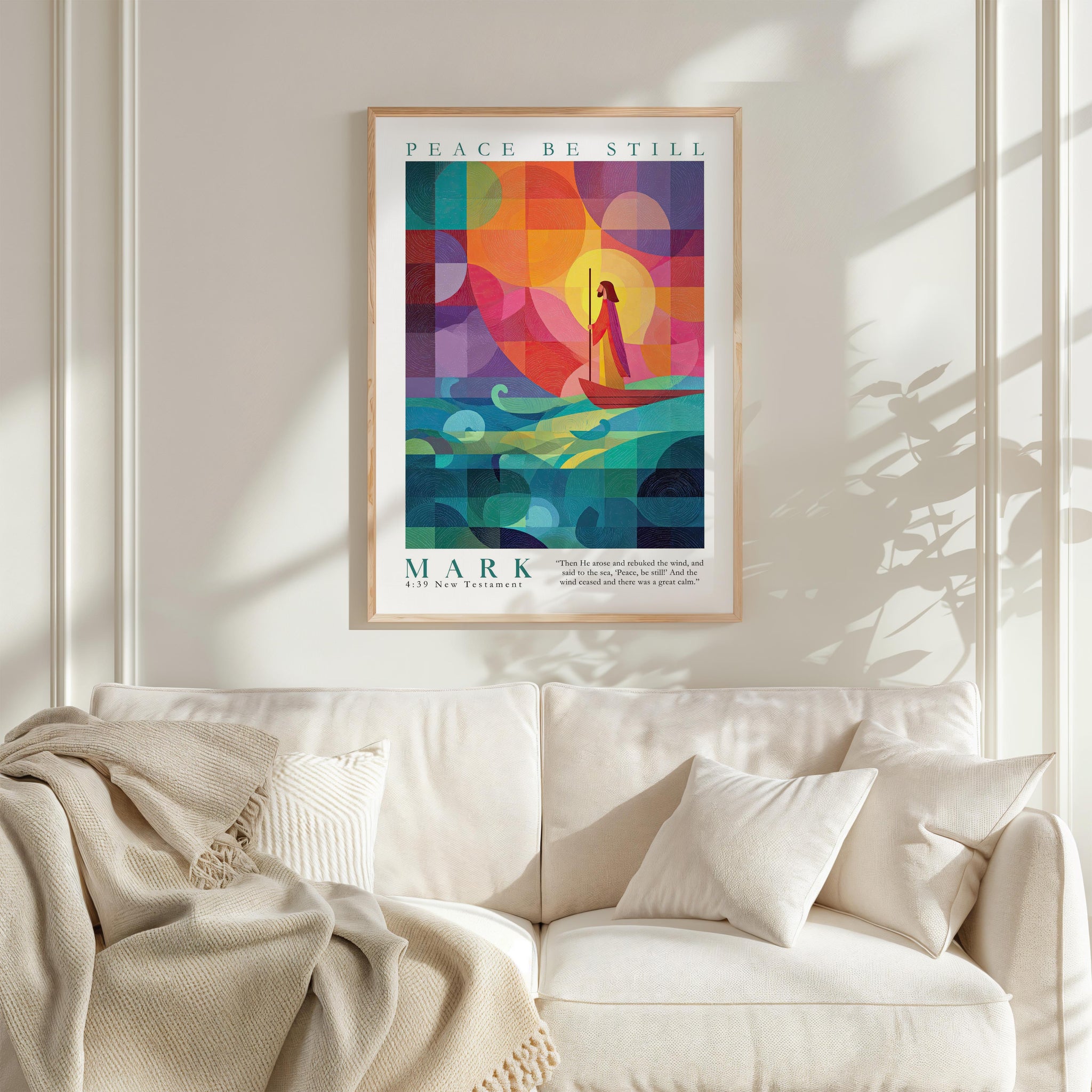 a vibrant poster of a sailboat on a colorful background, hanging on a wall above a white couch.