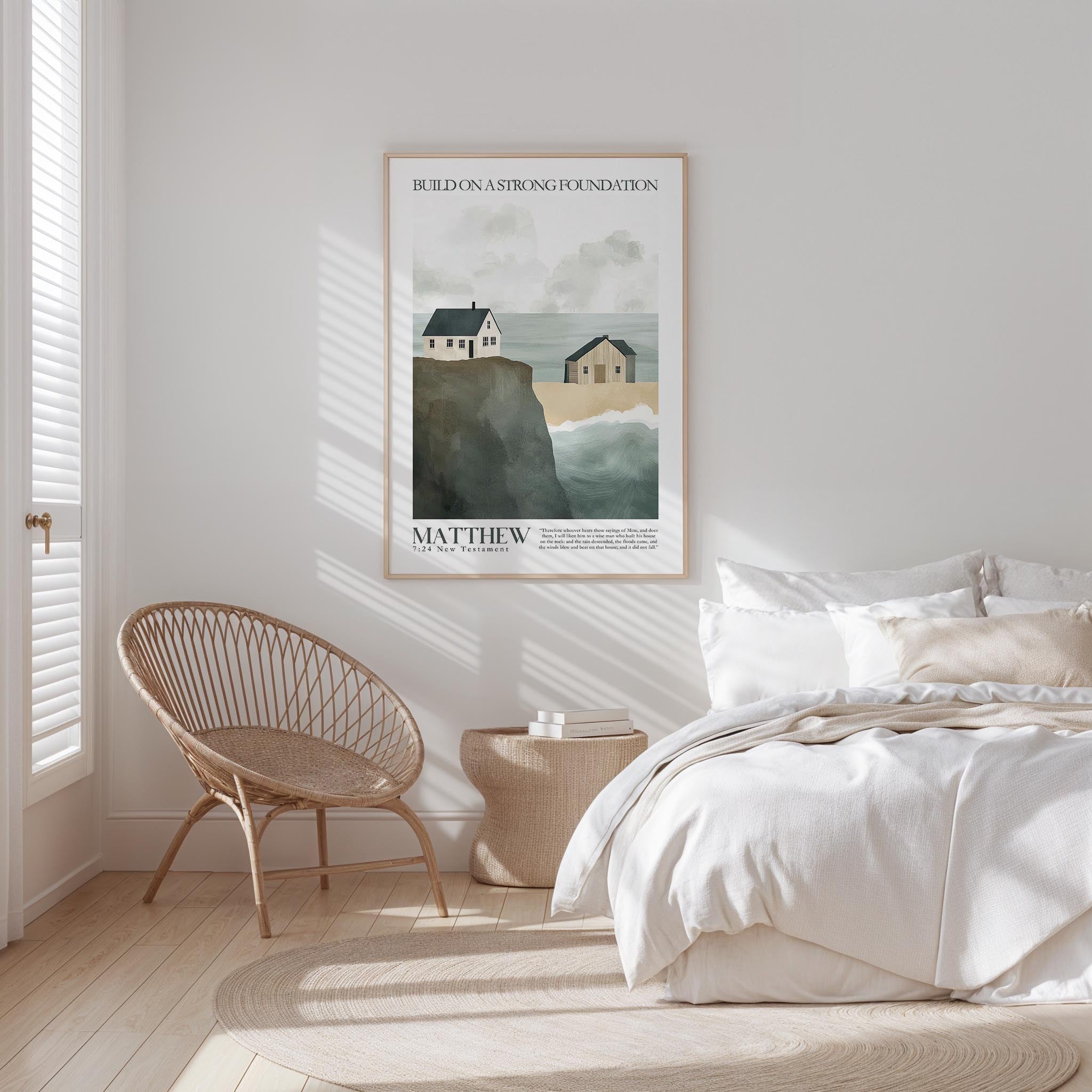 a serene bedroom scene with a bed, a woven chair, and a framed poster of a coastal landscape.
