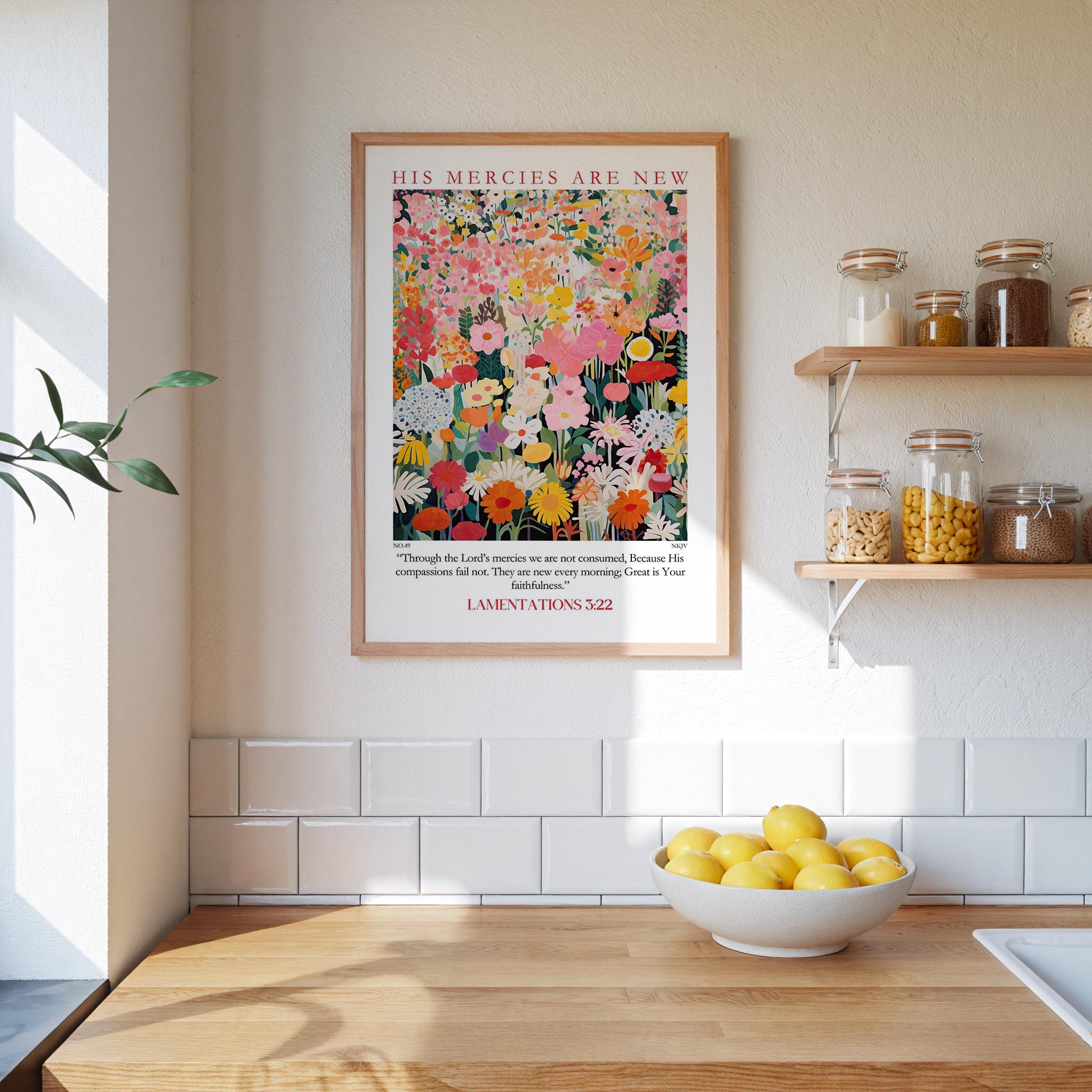 a kitchen scene with a framed poster of a colorful floral design hanging on the wall above a wooden countertop with a bowl of lemons.