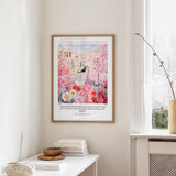 A framed poster of a colorful garden hangs on a wall, with a quote from Romans 8:28 visible below the image.