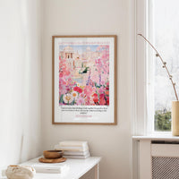 A framed poster of a colorful garden hangs on a wall, with a quote from Romans 8:28 visible below the image.