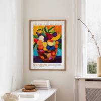 a framed poster of a vibrant fruit arrangement hanging on a wall in a room.