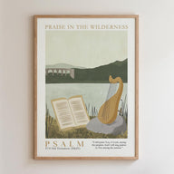 The image is a framed poster with a serene landscape featuring a river, mountains, and a bridge. The poster also includes a harp and an open book, suggesting a peaceful and contemplative atmosphere. The text "PRAISE IN THE WILDERNESS" is displayed at the top, and the bottom of the poster reads "PSALM 1759 OLD TESTAMENT (NkJ)" and includes a Bible verse from the book of Psalms.