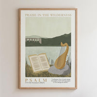 The image is a framed poster with a serene landscape featuring a river, mountains, and a bridge. The poster also includes a harp and an open book, suggesting a peaceful and contemplative atmosphere. The text "PRAISE IN THE WILDERNESS" is displayed at the top, and the bottom of the poster reads "PSALM 1759 OLD TESTAMENT (NkJ)" and includes a Bible verse from the book of Psalms.