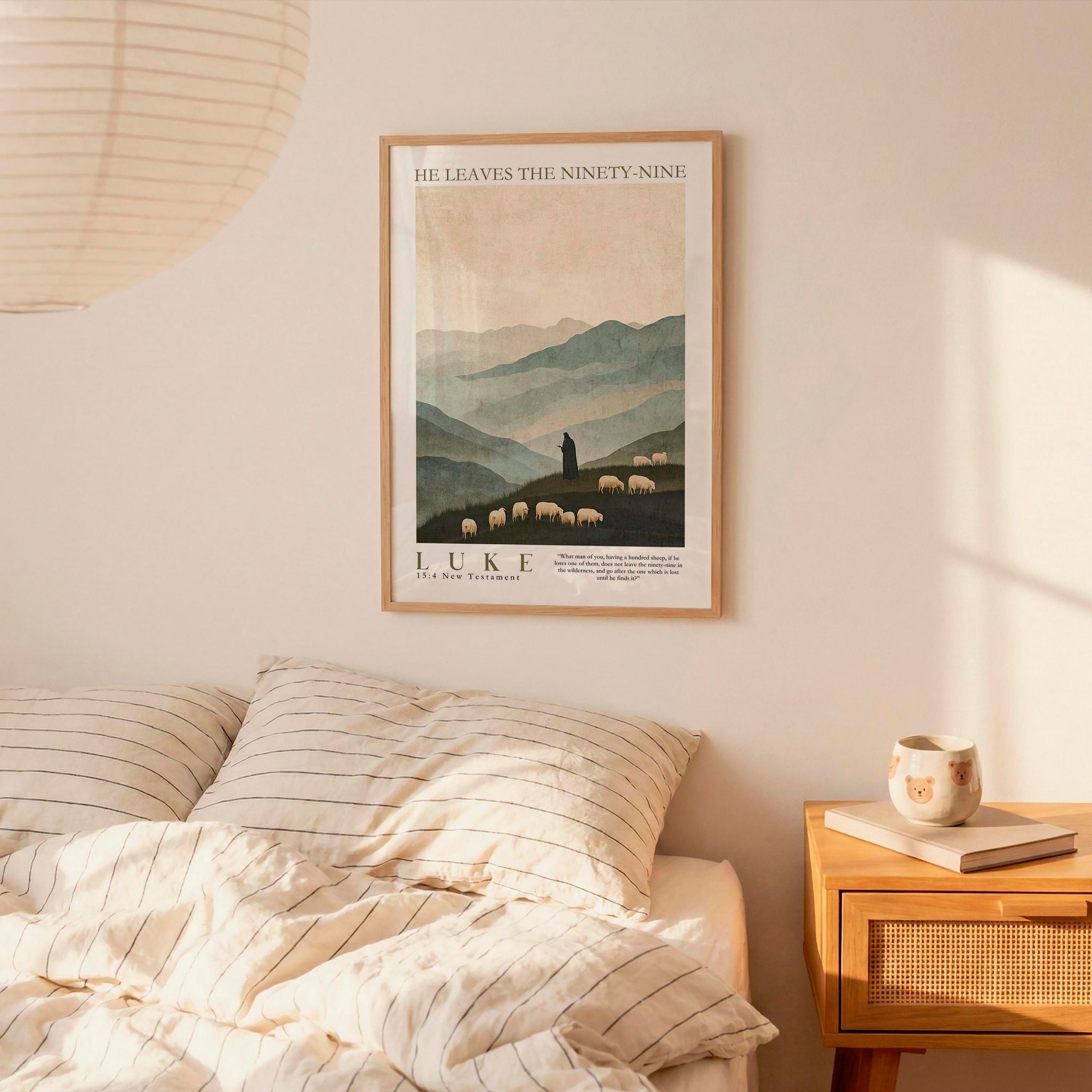 a bedroom scene with a framed poster of a mountain landscape hanging on the wall above a bed with striped bedding.