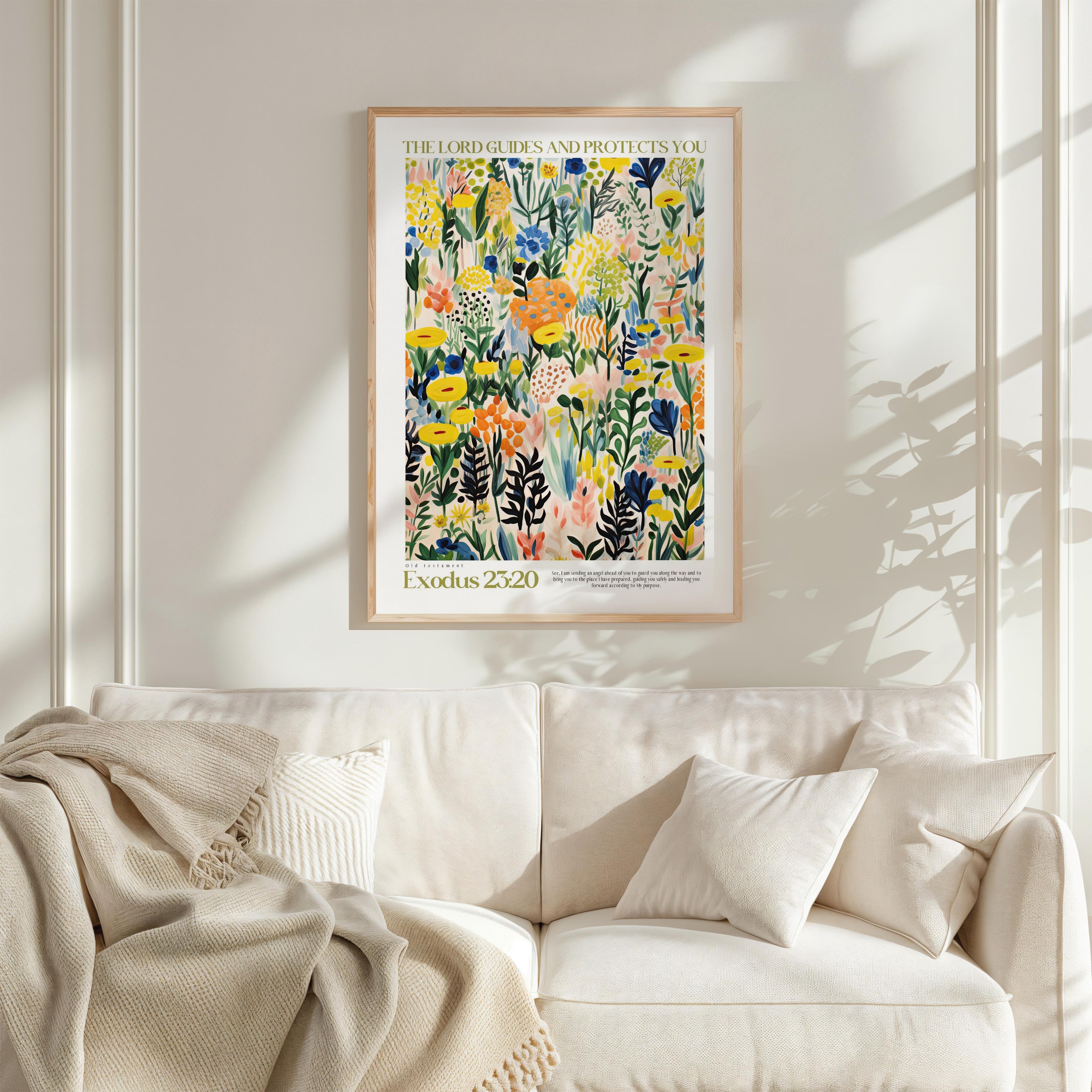 a vibrant, colorful painting of flowers and foliage hanging on a white wall above a white couch with a blanket draped over it.