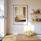 a kitchen scene with a framed poster of a window and curtains, a wooden counter with a bowl of lemons, and shelves displaying various jars and containers.