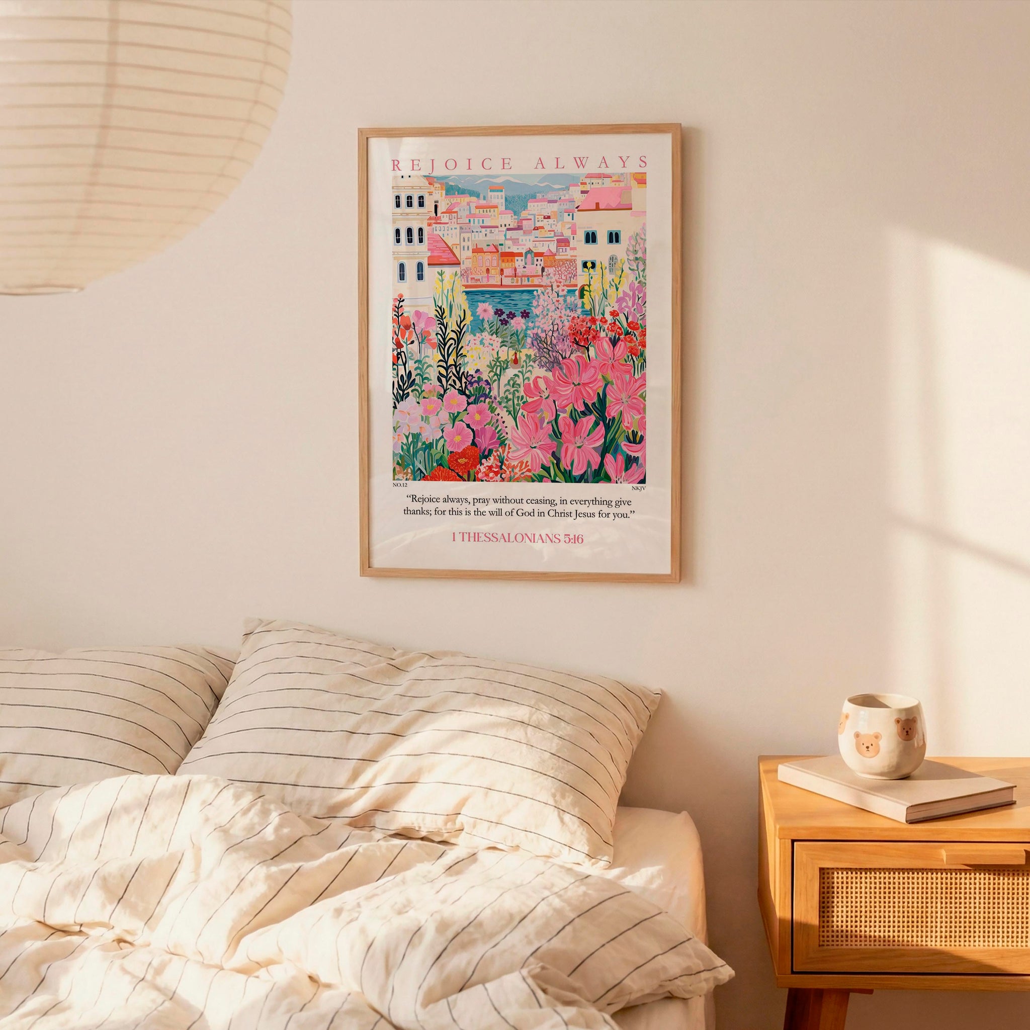 a bedroom scene with a framed poster of a colorful illustration of a cityscape hanging on the wall above a bed with striped pillows.
