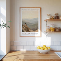A framed poster of a mountain landscape hangs on a wall above a wooden countertop with a bowl of lemons.