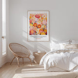 a serene bedroom scene with a bed, a woven chair, and a framed poster of a colorful floral design on the wall.