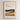 The image is a framed poster with a landscape depicting a field with tall grass and rolling hills. The poster has a minimalist design with a focus on the natural elements.