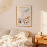 a bedroom scene with a framed poster of a religious illustration hanging on the wall above a bed with striped bedding.