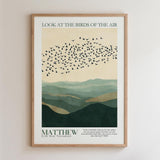 The image is a framed poster with a minimalist design featuring a flock of birds flying over a mountainous landscape. The text on the poster reads "Look at the birds of the air" and "MATTHEW 26 New Testament".