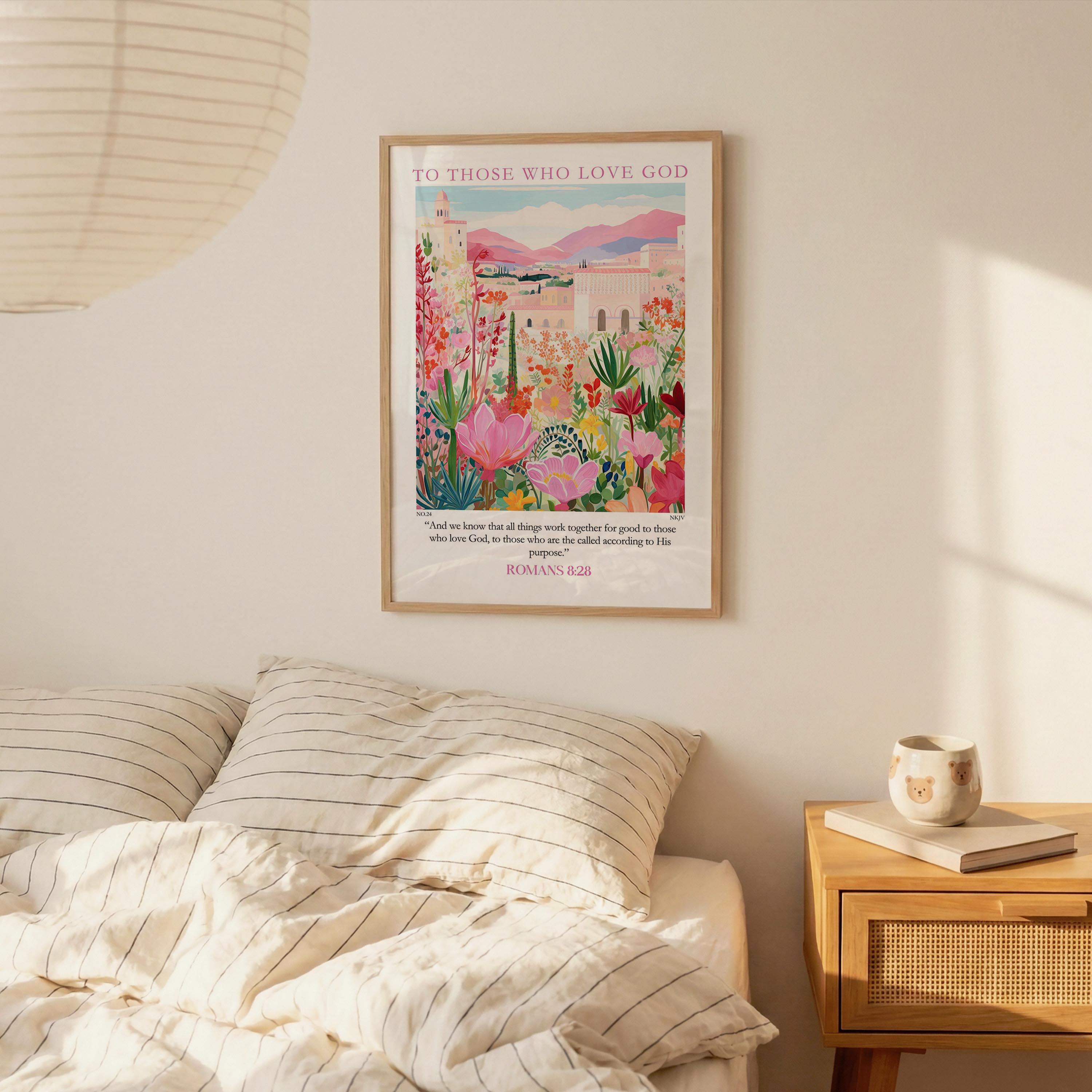 a bedroom setting with a framed poster of a colorful floral landscape hanging on the wall above a bed with striped bedding.