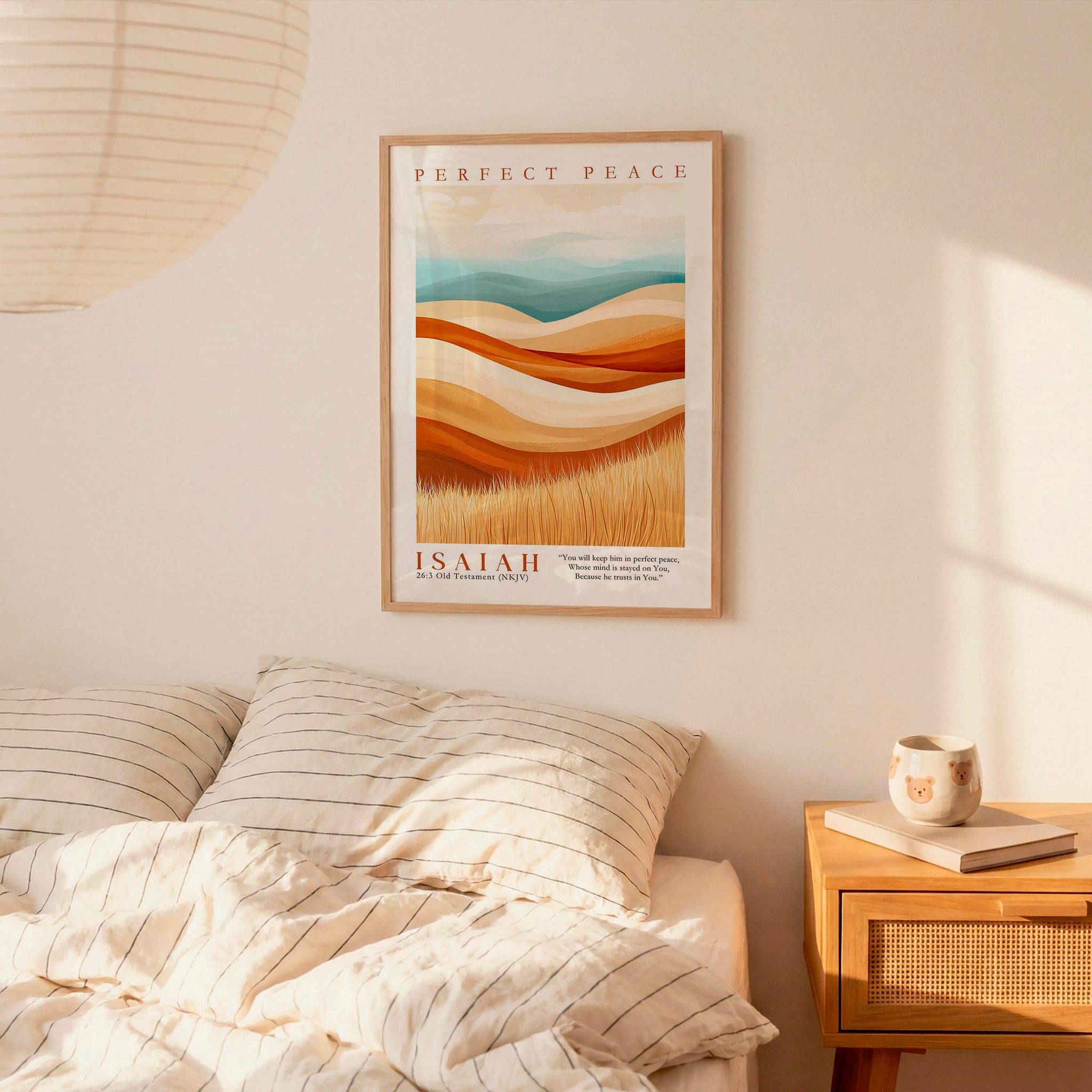 a bedroom scene with a framed poster of a landscape hanging on the wall above a bed with striped bedding.