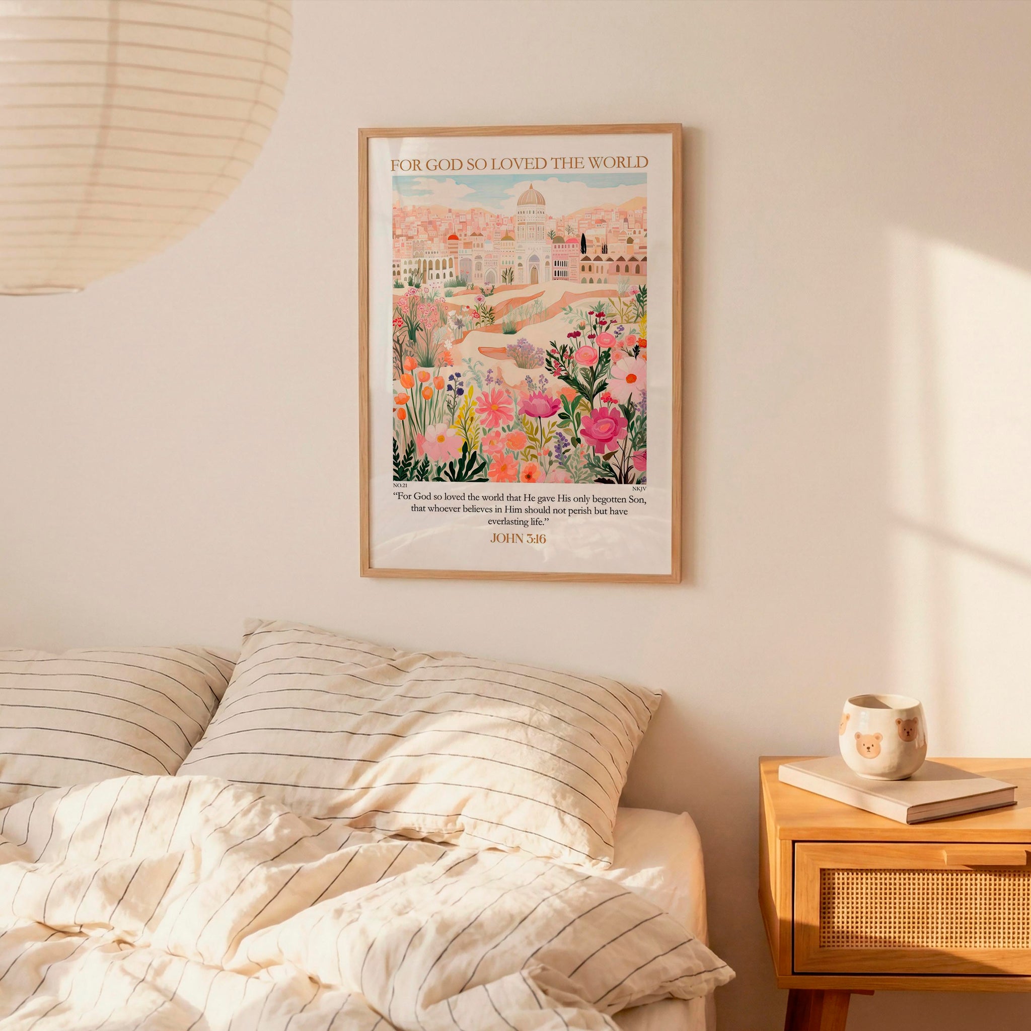 a bedroom scene with a framed poster of a cityscape hanging on the wall above a bed with striped pillows.