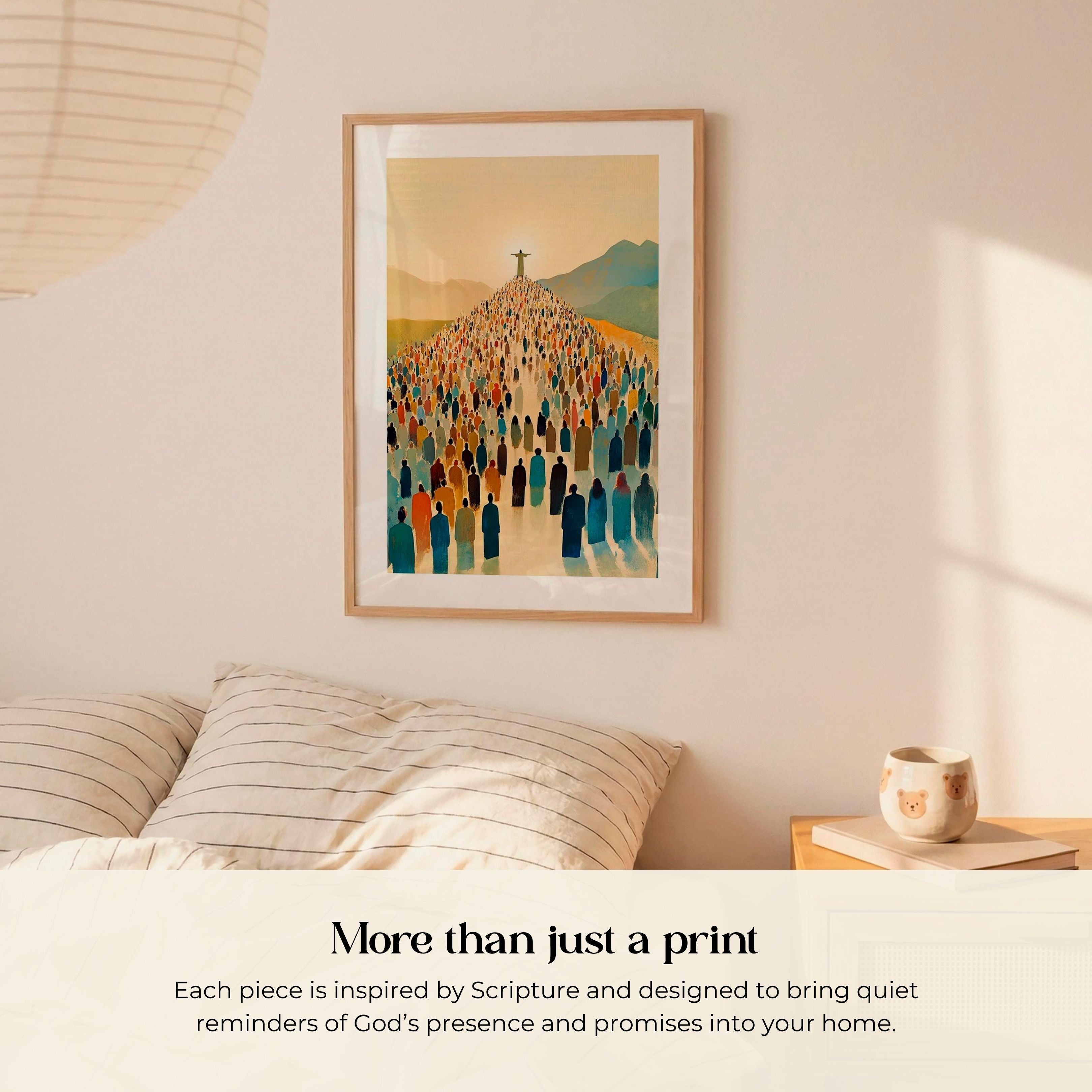 a framed artwork of a large crowd of people, with a cross in the background, hanging on a wall above a bed with striped pillows.