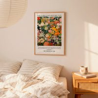 a bedroom scene with a framed poster of a colorful floral design hanging on the wall above a bed with striped pillows.