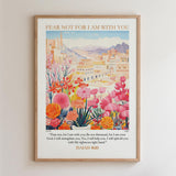 The image is a framed poster with a colorful illustration of a cityscape and flowers. The poster includes a Bible verse from Isaiah 40:10, which encourages the viewer to "Fear not, for I am with you" and to "Be not dismayed, for I am your God. I will strengthen you, Yes, I will help you, I will uphold you with My righteous ways."