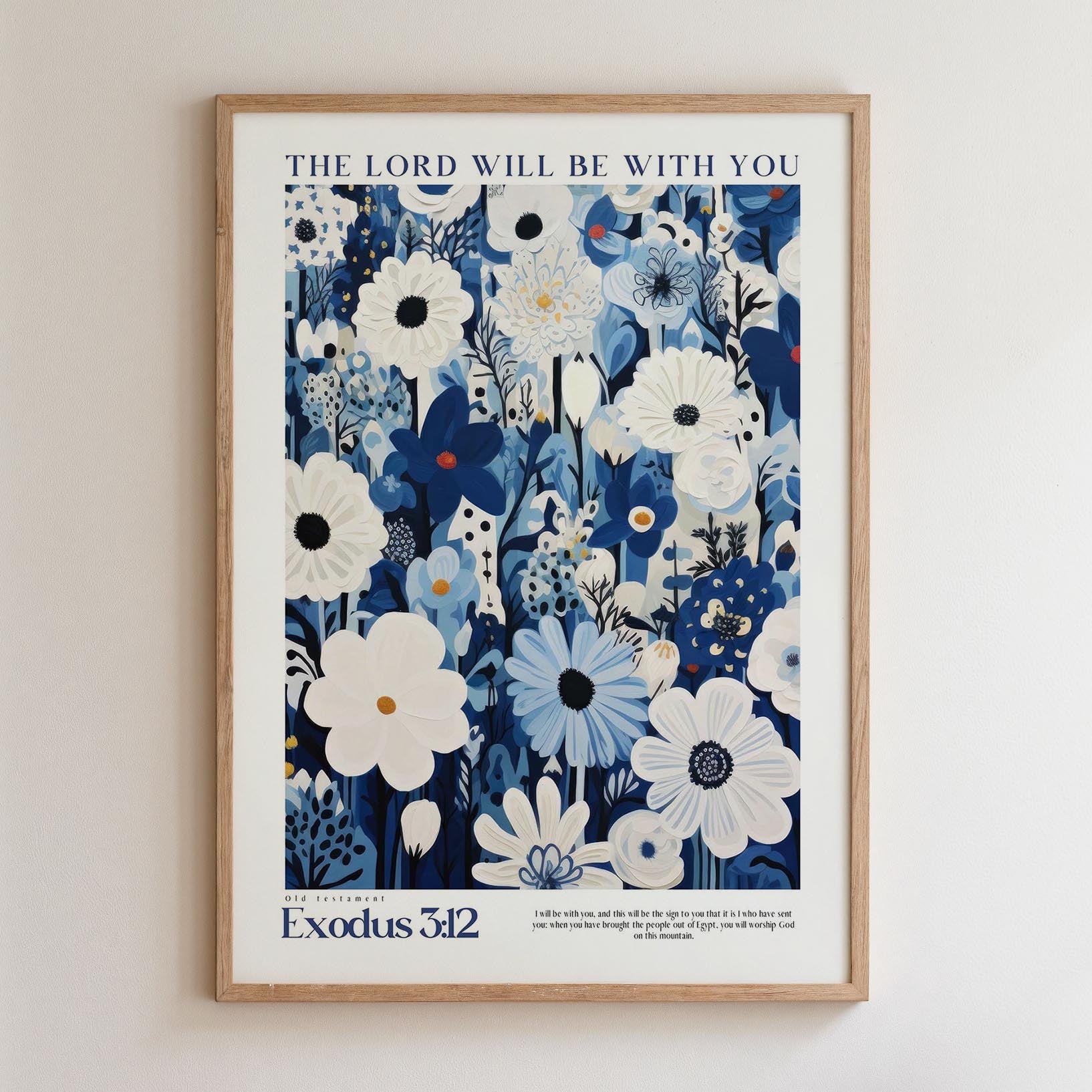 The image is a framed poster with a floral design and text. The poster is titled "The Lord will be with you" and features a biblical verse from the book of Exodus. The poster is hung on a wall.