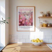 a kitchen counter with a bowl of lemons, a framed poster of a cityscape, and a shelf with jars and containers.
