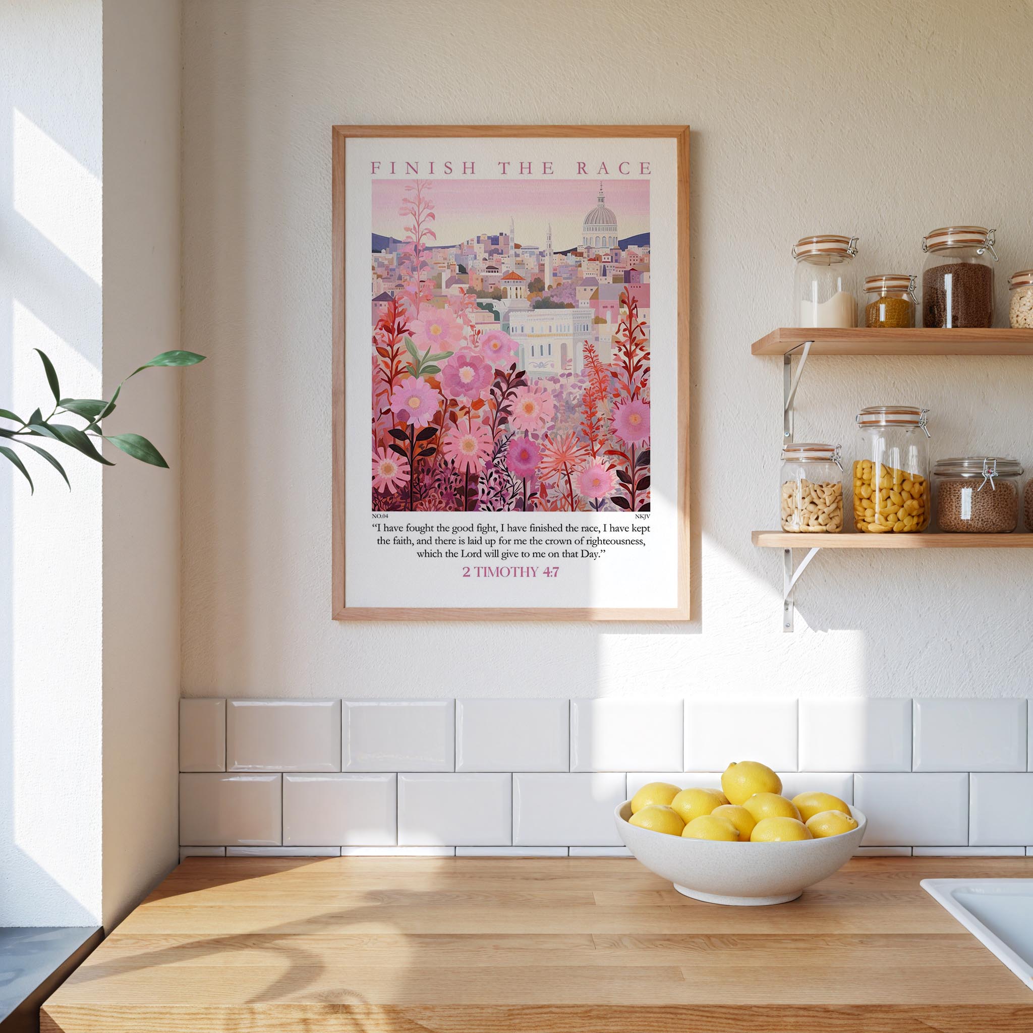 a kitchen counter with a bowl of lemons, a framed poster of a cityscape, and a shelf with jars and containers.