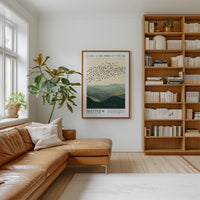 a cozy living room with a large bookshelf filled with books, a comfortable leather couch, and a framed poster of birds in flight on the wall.