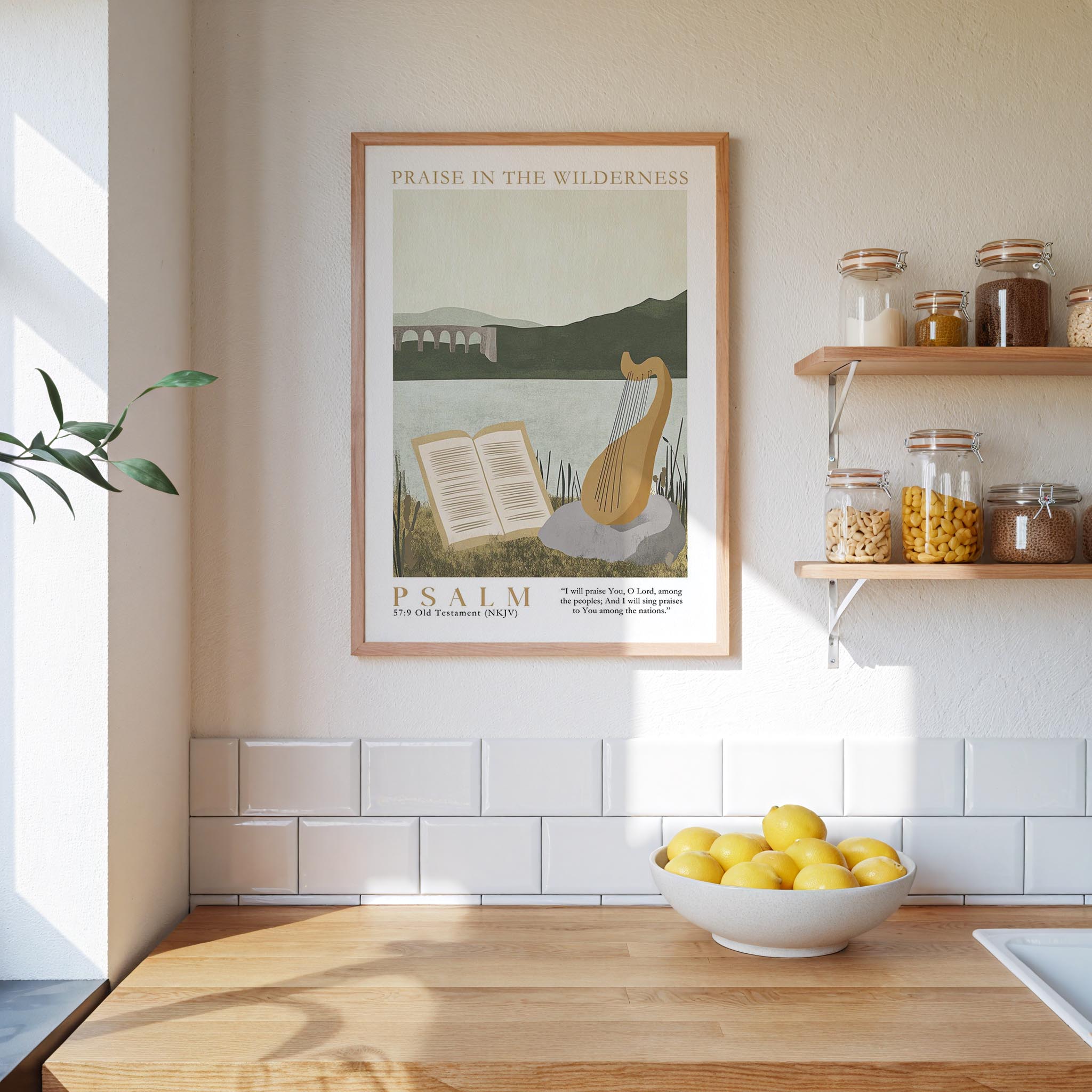 A framed poster of Psalm 17:9 hangs on a white wall above a wooden countertop with a bowl of lemons.