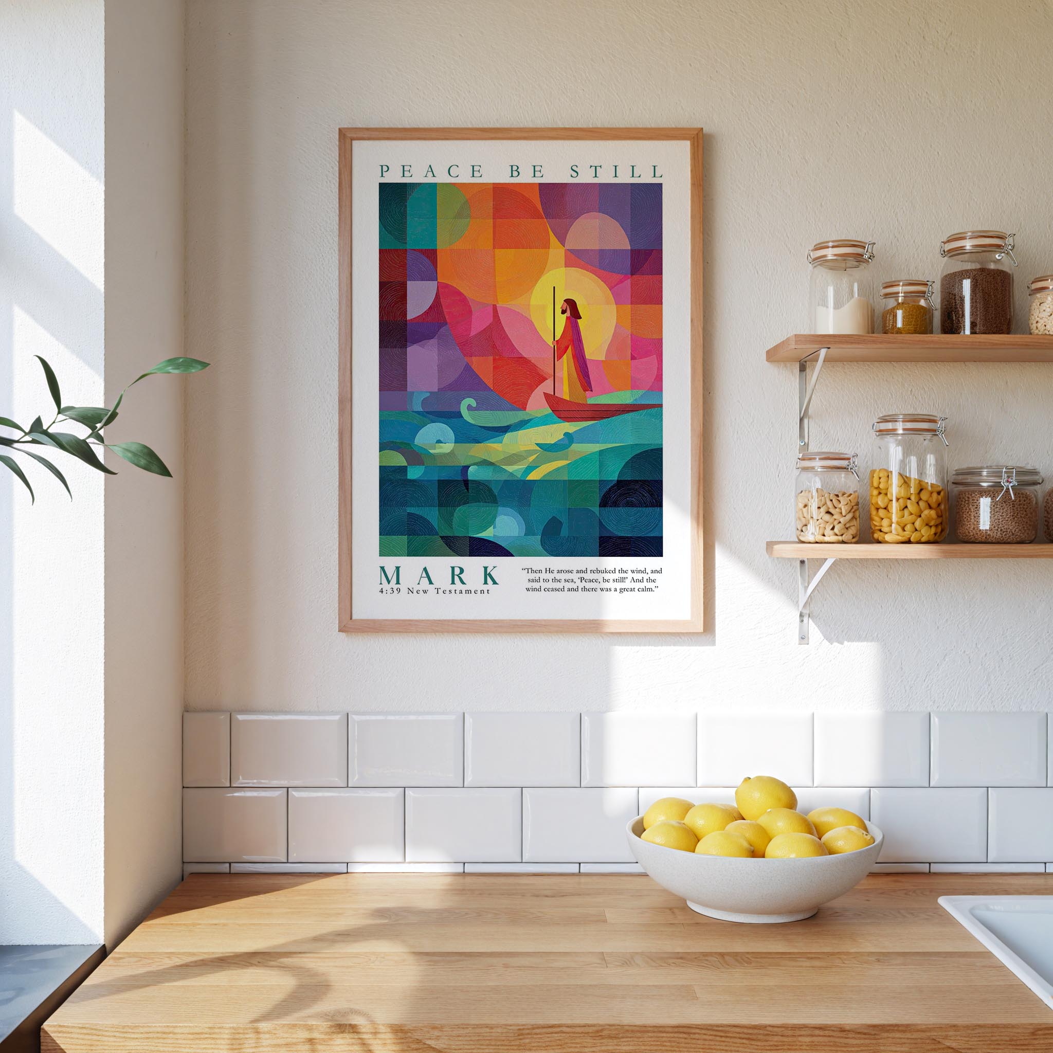 a kitchen counter with a bowl of lemons, a plant, and a framed poster of a colorful abstract design hanging on the wall above it.