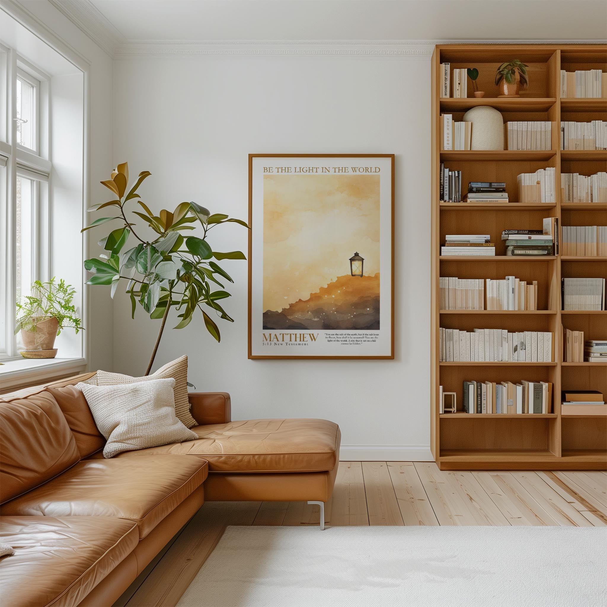 a cozy living room with a large bookshelf filled with books, a comfortable leather couch, and a framed poster of a lighthouse on the wall.