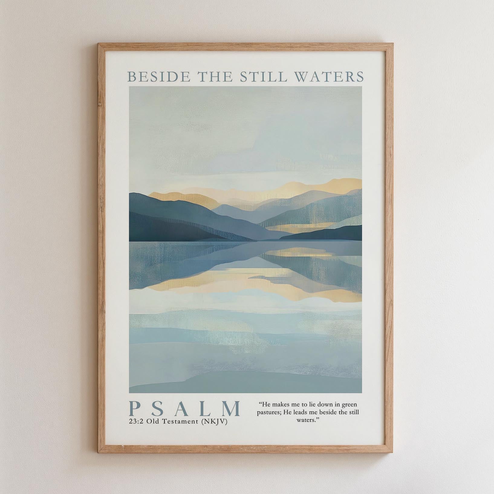 The image is a framed poster with a serene landscape depicting a calm body of water surrounded by mountains. The text "BESIDE THE STILL WATERS" is written at the top of the poster, and the phrase "PSALM" is written at the bottom. The poster also includes a Bible verse from the Old Testament (NIV) that reads, "He makes us to lie down in green pastures, leads us beside the still waters."