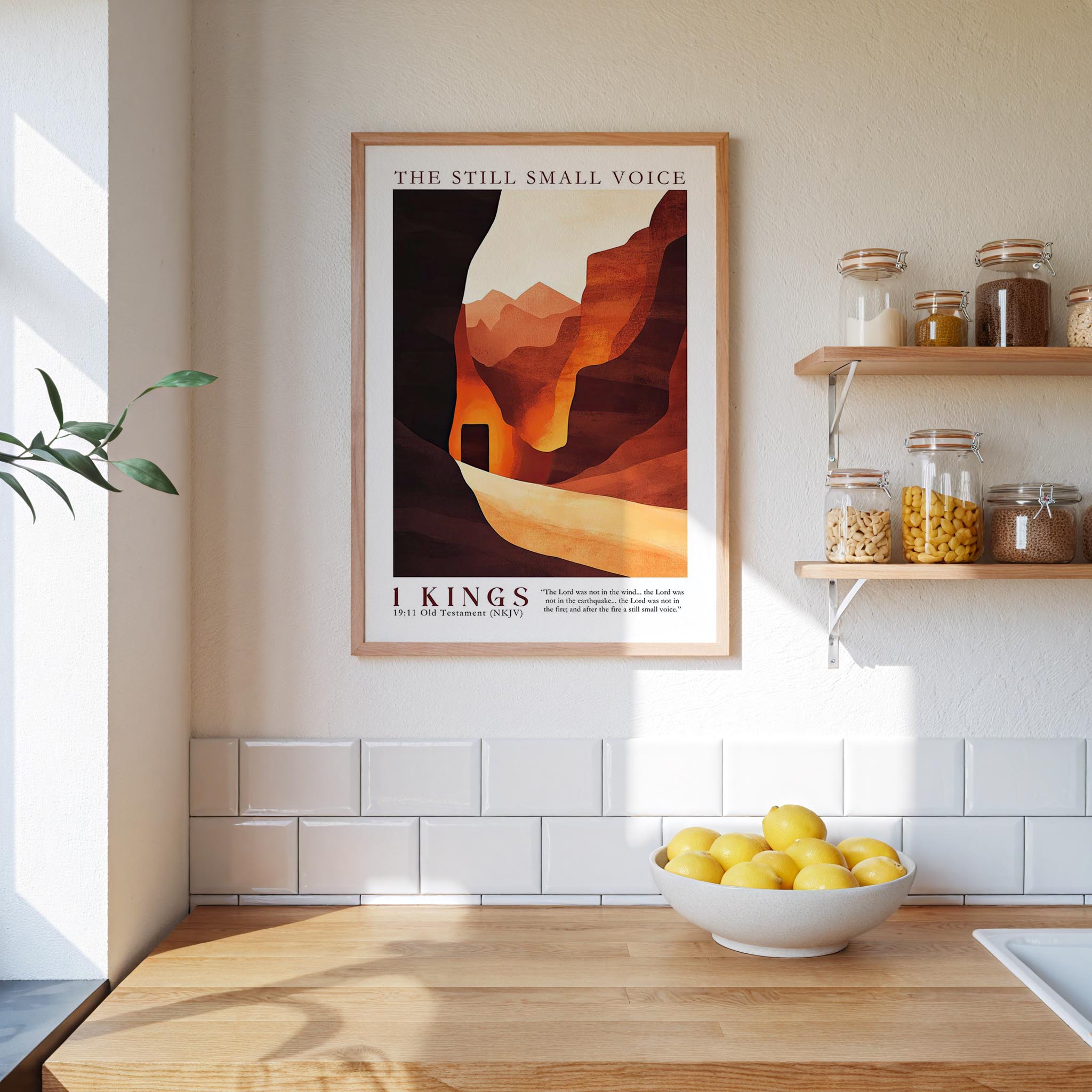 a kitchen counter with a bowl of lemons, a framed poster of a desert landscape, and a shelf with jars and other kitchen items.