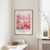 a framed poster of a colorful, floral landscape hanging on a wall, with a quote from Isaiah 4:3 visible below the artwork.