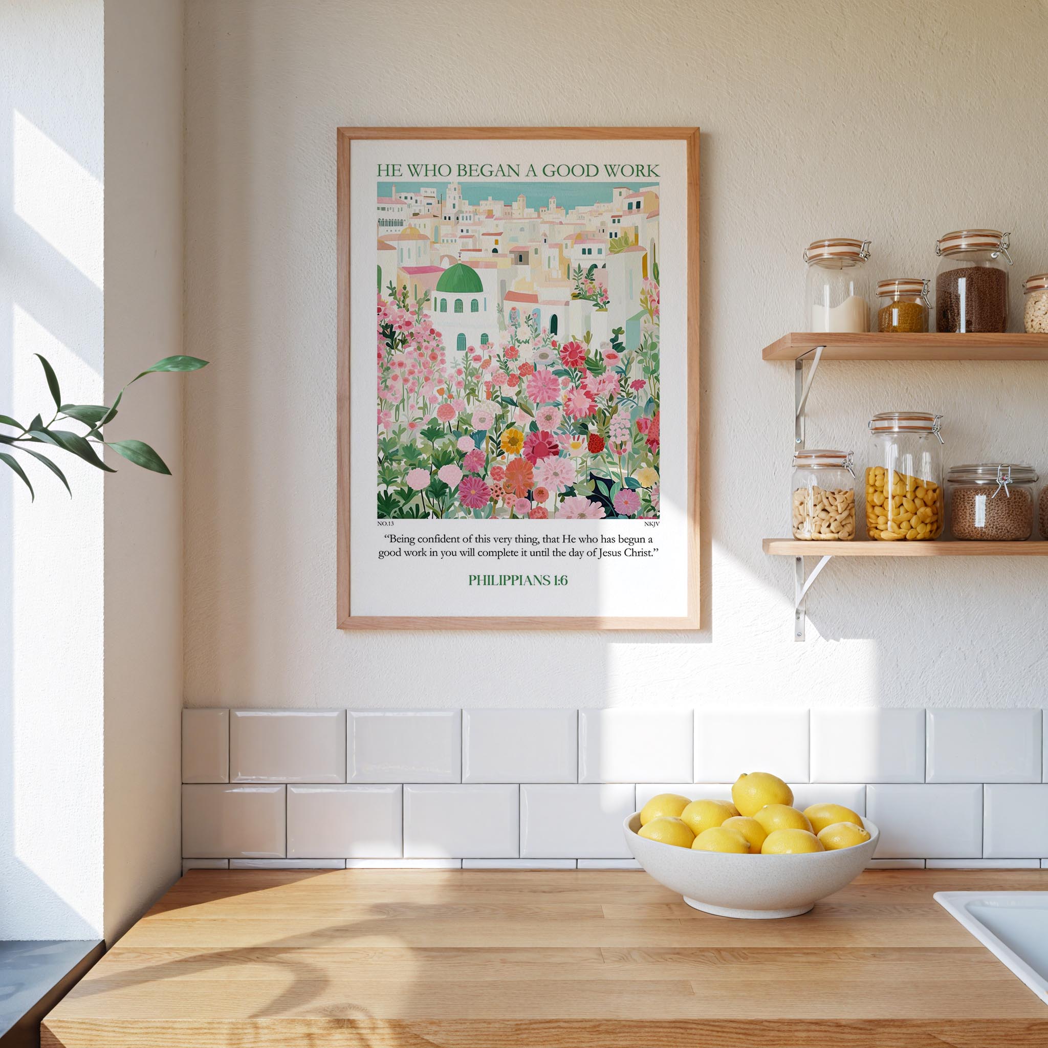 a kitchen scene with a framed poster of a colorful illustration of a cityscape, a bowl of lemons, and shelves with jars and containers.
