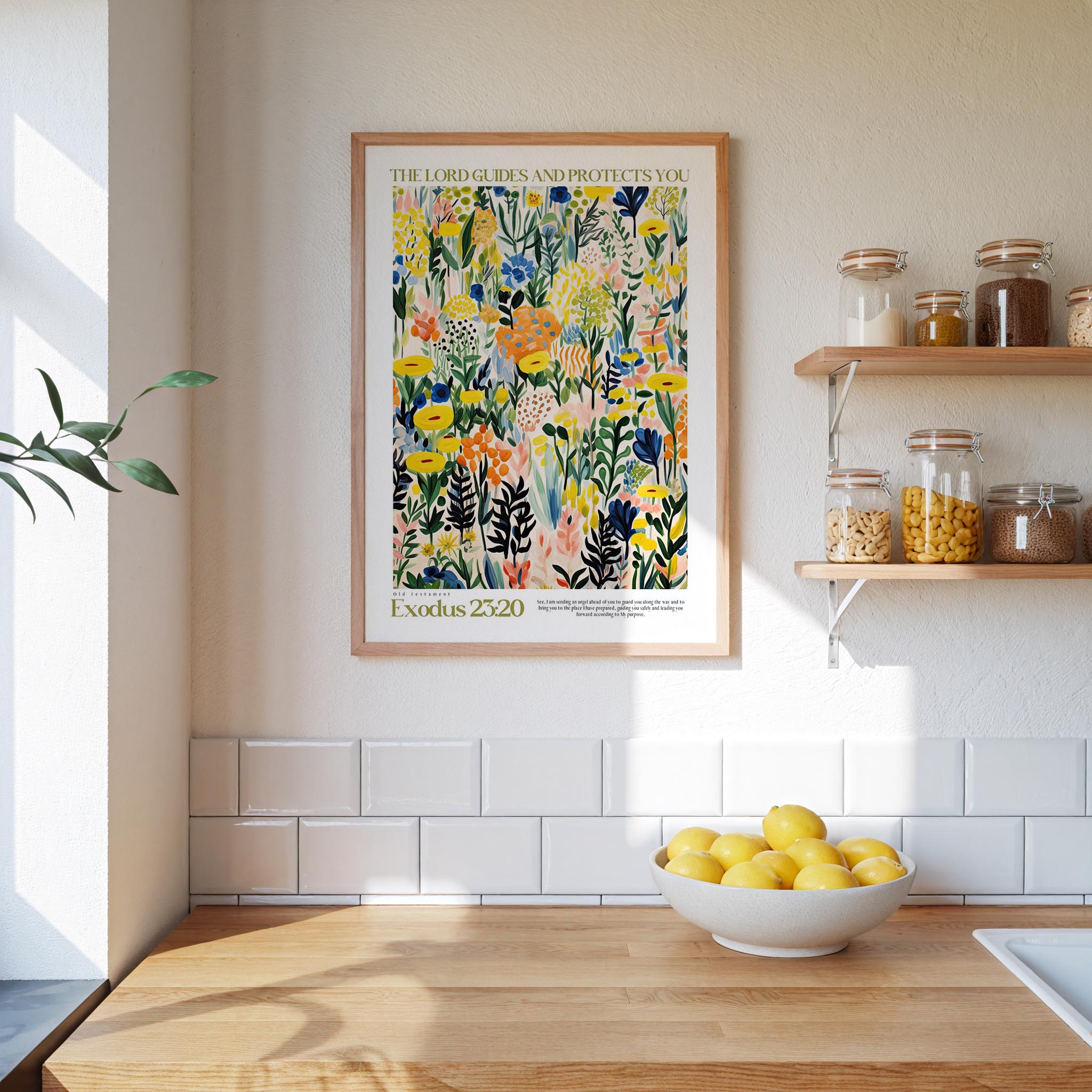 a kitchen scene with a framed poster of a colorful floral design hanging on the wall above a wooden countertop with a bowl of lemons.