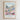 The image is a framed poster with a painting of a cityscape filled with colorful flowers and buildings. The poster is titled "STRENGTH THROUGH CHRIST" and includes a Bible verse from Philippians 4:12.