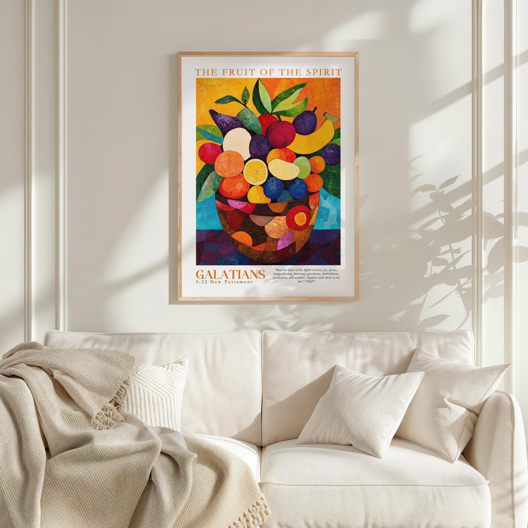 a vibrant, colorful painting of a bowl filled with various fruits, such as apples, oranges, and bananas, hanging on a wall above a white couch.
