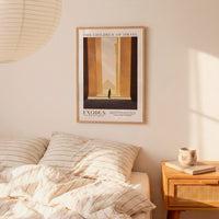 a bedroom scene with a framed poster of a building and a bed with striped bedding.