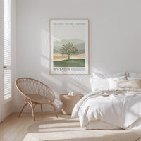 a serene bedroom scene with a bed, a woven chair, and a framed poster of a tree on the wall.