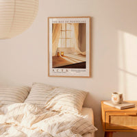 a bedroom scene with a framed poster of a window and curtains hanging on the wall above a bed with striped bedding.