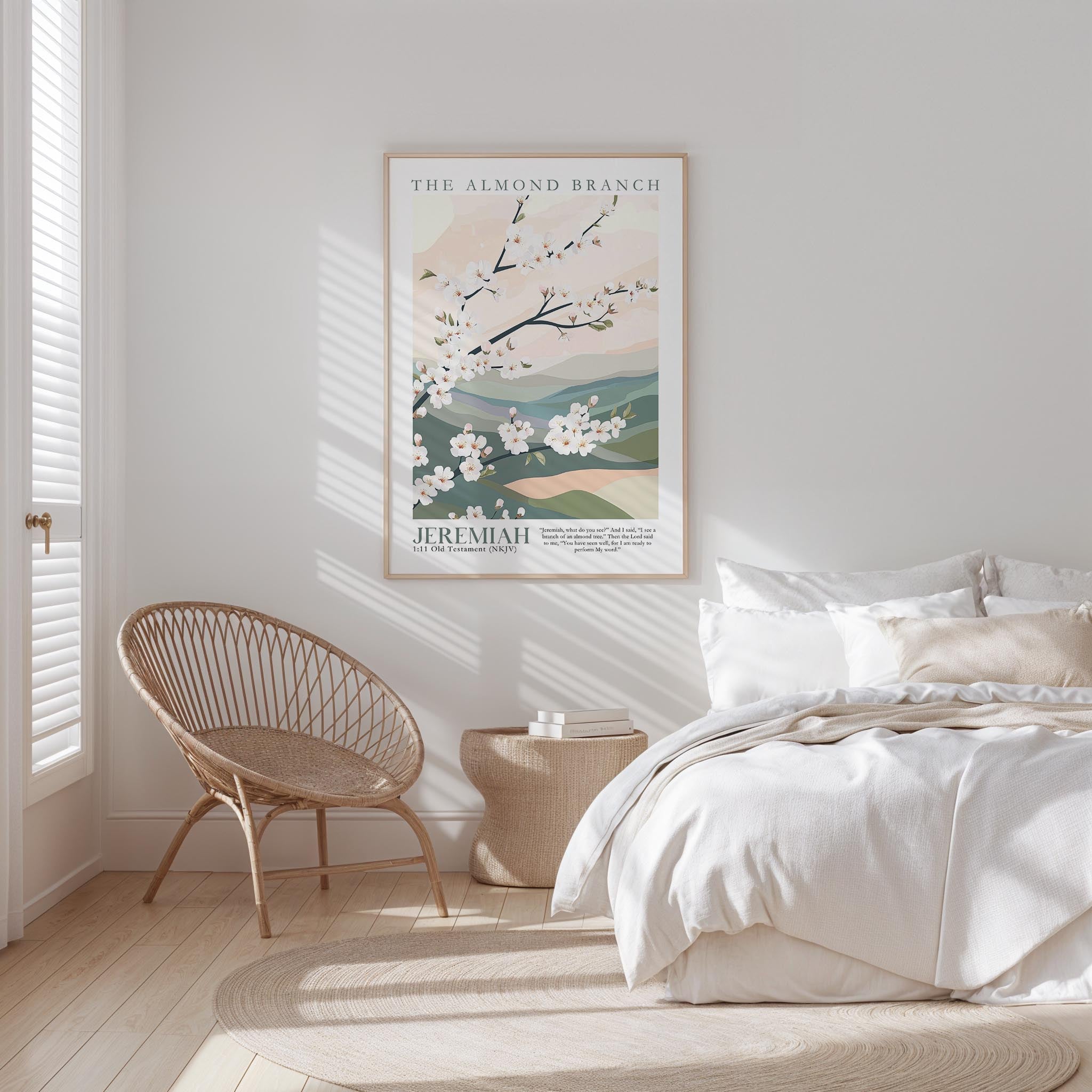 a serene bedroom scene with a bed, a woven chair, and a framed poster of a blooming tree on the wall.